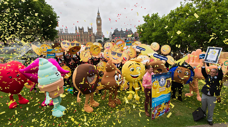 LONDON, ENGLAND - July 17, 2017: Vyv Evans (UK'S leading Emoji expert) and Jack Brockbank (Guinness World Record official Adjudicator) with Emoji at St. Thomas Hospital Garden set the Guinness World Record with 537 people around the world for the largest gathering of people dressed as emoji faces in celebration of World Emoji Day and Columbia Pictures' THE EMOJI MOVIE.